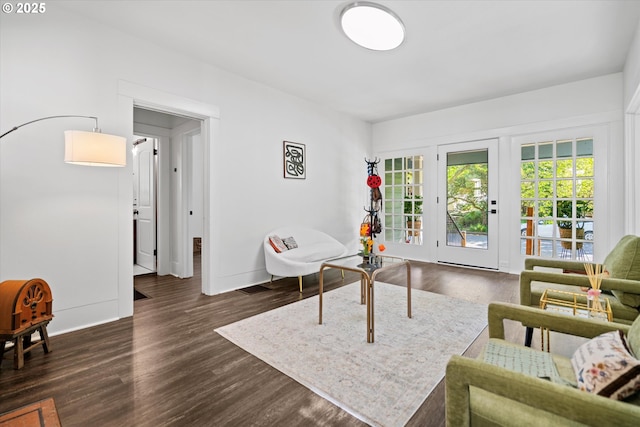 living area featuring baseboards and dark wood-style floors