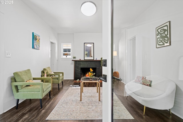 1605 SE 46th Ave, Portland, OR 97215 - sitting room with dark wood-style floors and a brick fireplace