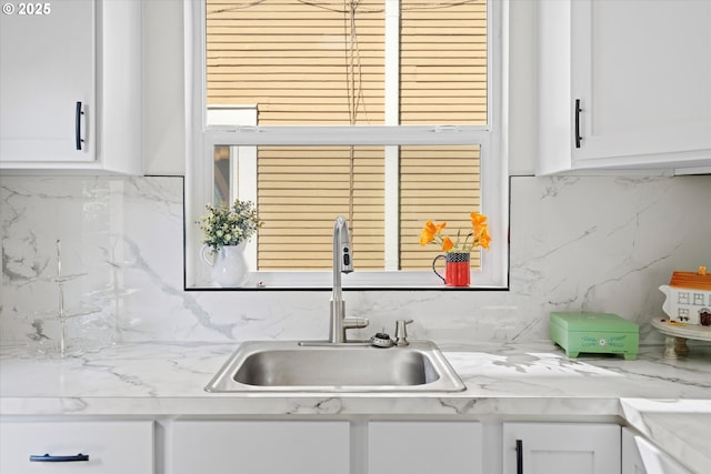 1605 SE 46th Ave, Portland, OR 97215 - kitchen featuring decorative backsplash, white cabinets, and light countertops