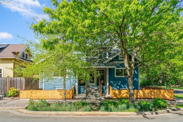 obstructed view of property featuring a fenced front yard