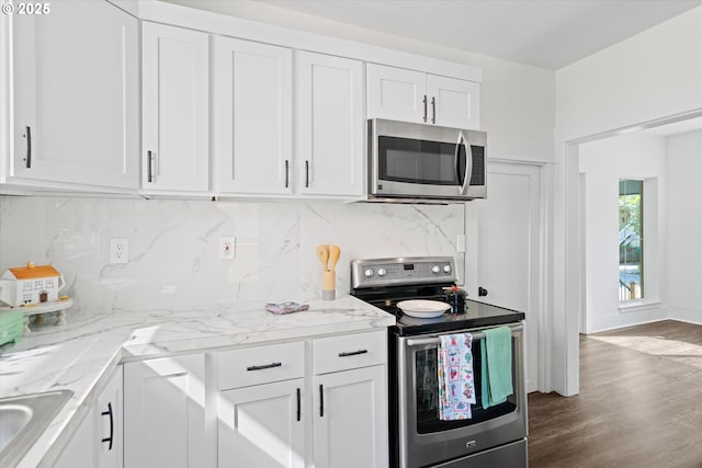 1605 SE 46th Ave, Portland, OR 97215 - kitchen featuring stainless steel appliances, white cabinets, and tasteful backsplash