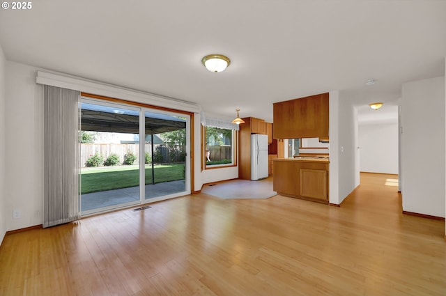 4095 Eddystone Pl, Eugene, OR 97404 - unfurnished living room with light wood-style floors and baseboards