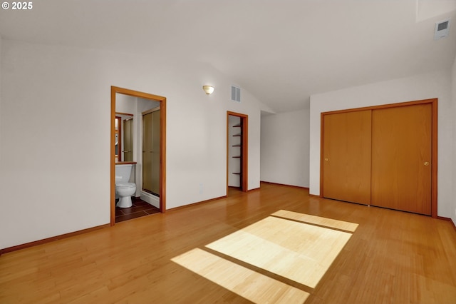 4095 Eddystone Pl, Eugene, OR 97404 - unfurnished bedroom with wood finished floors, baseboards, and connected bathroom