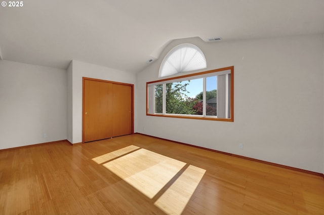 4095 Eddystone Pl, Eugene, OR 97404 - unfurnished bedroom featuring lofted ceiling, baseboards, light wood-type flooring, and a closet