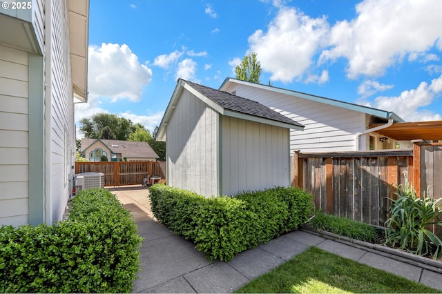 4095 Eddystone Pl, Eugene, OR 97404 - view of side of property featuring central air condition unit, fence, an outbuilding, and a shed