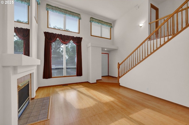 4095 Eddystone Pl, Eugene, OR 97404 - foyer entrance featuring a high ceiling, stairs, wood finished floors, and a tiled fireplace