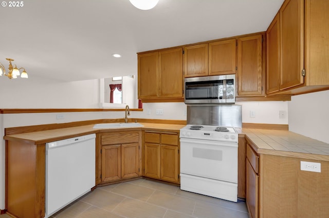4095 Eddystone Pl, Eugene, OR 97404 - kitchen with white appliances, a sink, tile counters, a peninsula, and recessed lighting