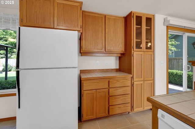 4095 Eddystone Pl, Eugene, OR 97404 - kitchen featuring freestanding refrigerator, tile counters, and light tile patterned floors