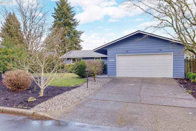 single story home featuring driveway and an attached garage