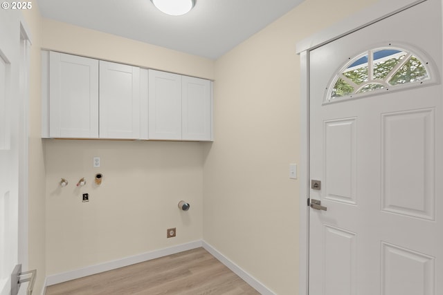 laundry room with light wood-style floors, hookup for a gas dryer, cabinet space, and baseboards