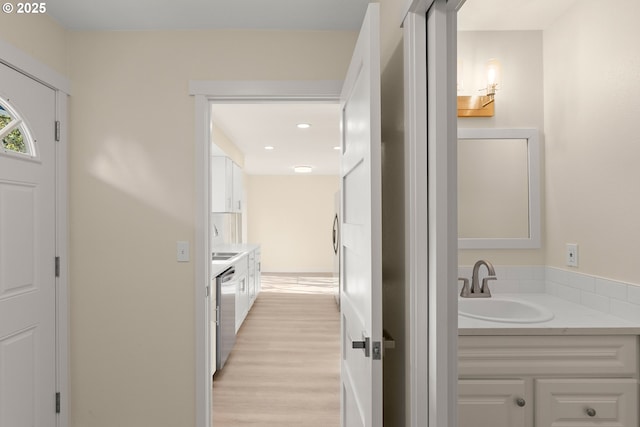 interior space with wood finished floors, vanity, and recessed lighting