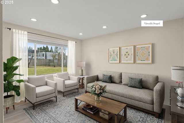 living room with light wood-style floors and recessed lighting