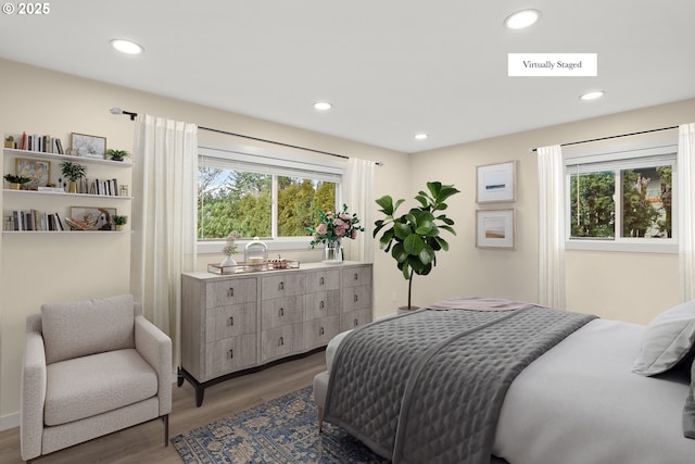 bedroom featuring wood finished floors, visible vents, and recessed lighting