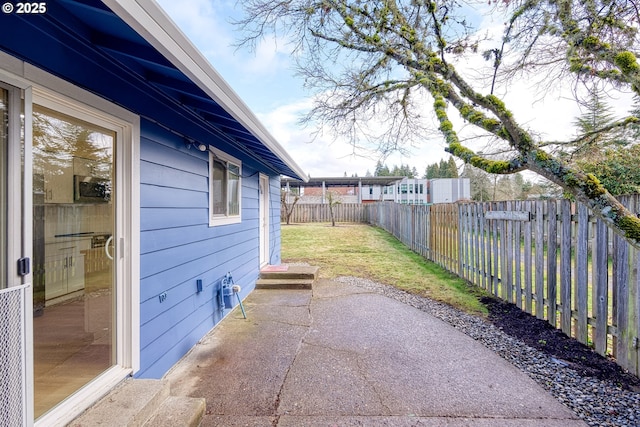 exterior space with a patio area and a fenced backyard