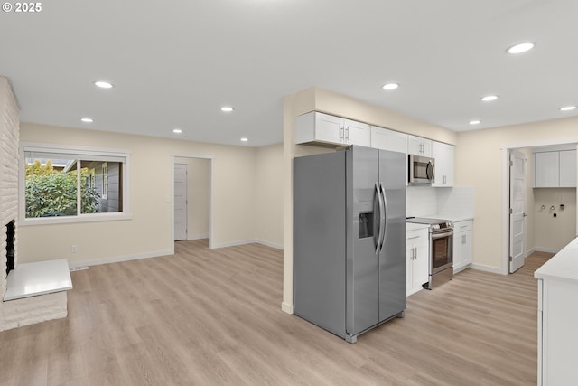 kitchen with light wood-style flooring, stainless steel appliances, light countertops, white cabinetry, and recessed lighting