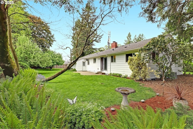 8730 SW Barnes Rd, Portland, OR 97225 - rear view of house featuring a patio area, a chimney, and a lawn