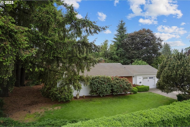 8730 SW Barnes Rd, Portland, OR 97225 - view of property hidden behind natural elements with a garage, a front yard, and driveway