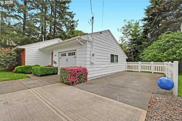 8730 SW Barnes Rd, Portland, OR 97225 - view of side of home with concrete driveway and an attached garage