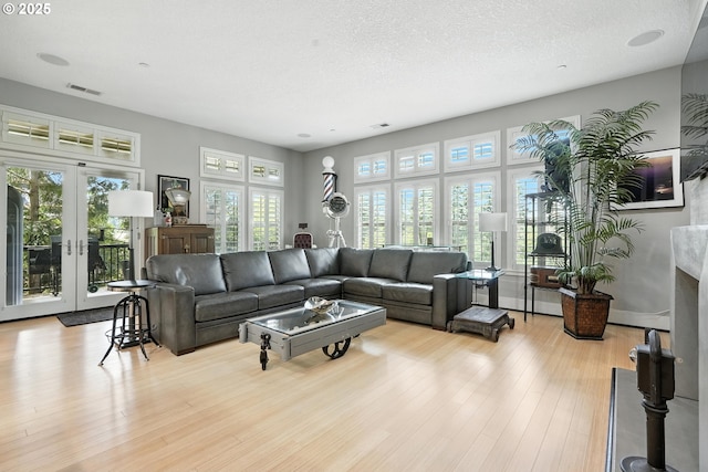10155 SW Morrison St, Portland, OR 97225 - living area featuring plenty of natural light, wood finished floors, french doors, and a textured ceiling