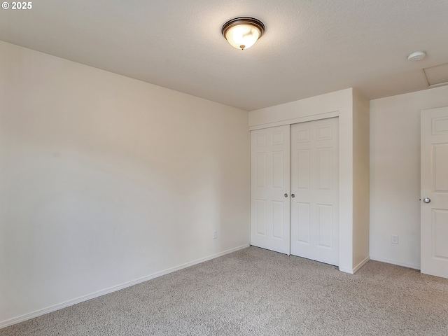 unfurnished bedroom with a closet, baseboards, and carpet