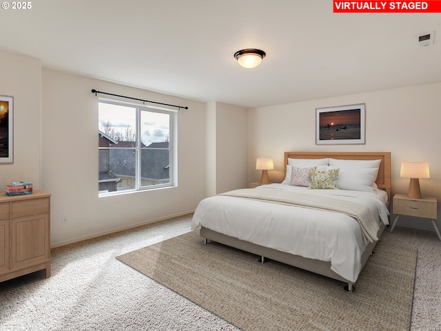 bedroom featuring baseboards, light carpet, and visible vents