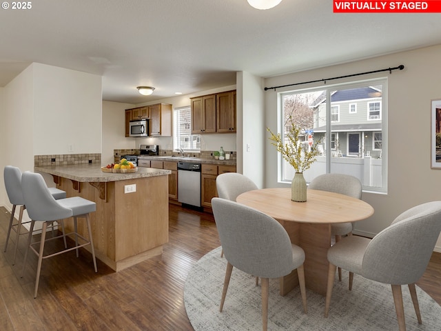 dining area featuring dark wood-style floors