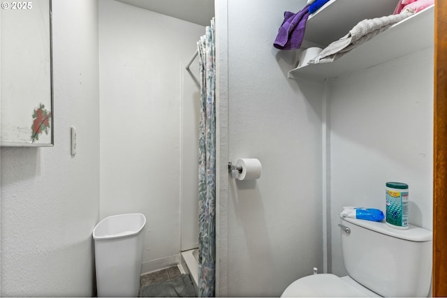 full bathroom featuring toilet and curtained shower