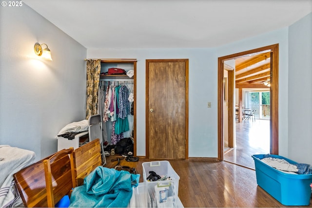 bedroom featuring baseboards and wood finished floors