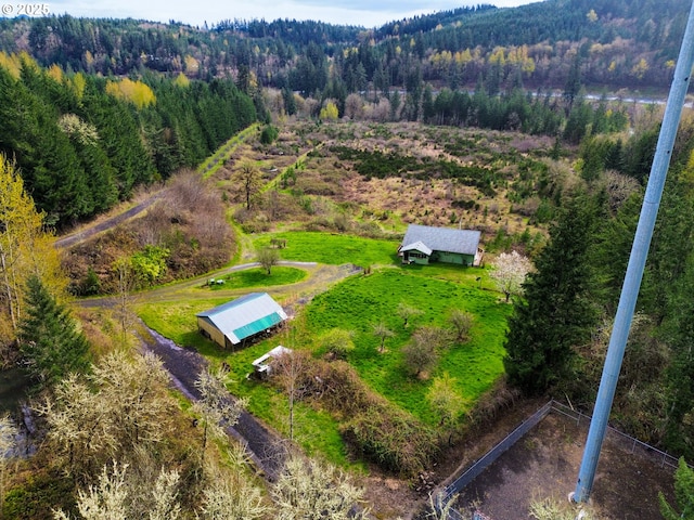 aerial view featuring a rural view and a wooded view
