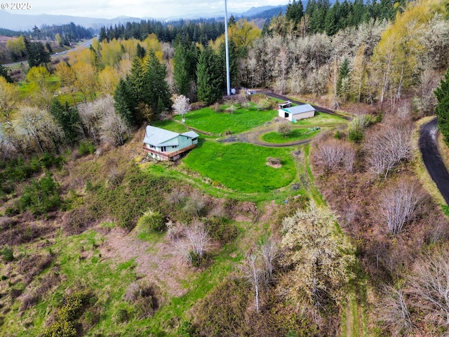 birds eye view of property featuring a wooded view