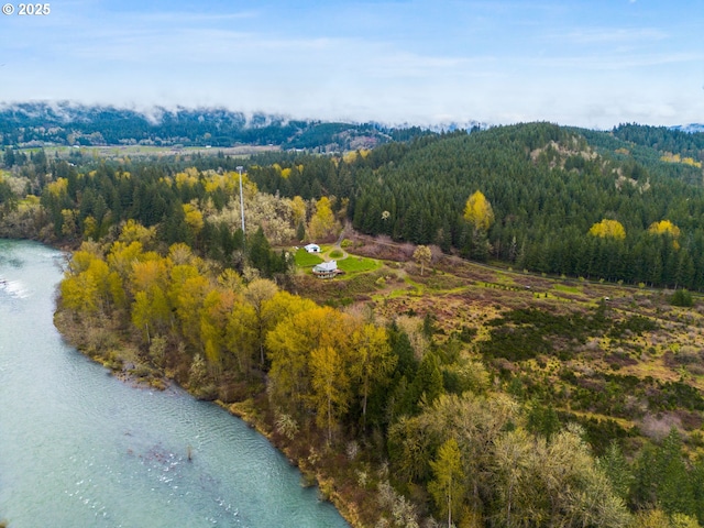 birds eye view of property with a view of trees