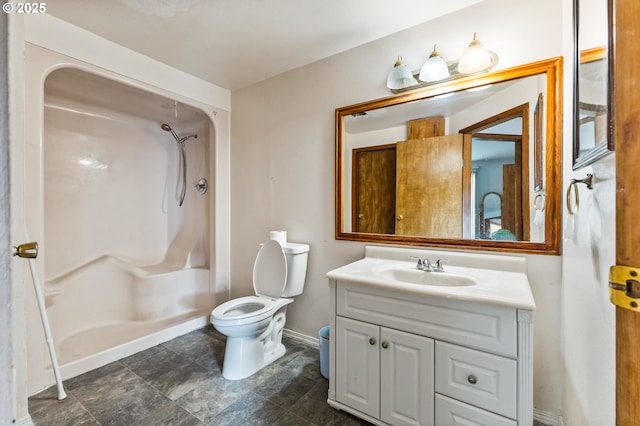 full bathroom with baseboards, toilet, vanity, and a shower