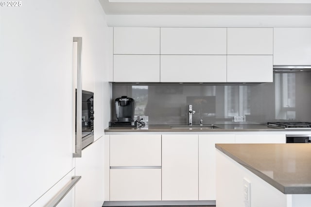 1075 NW Northrup St Unit 814, Portland, OR 97209 - kitchen featuring white cabinets, a sink, and modern cabinets