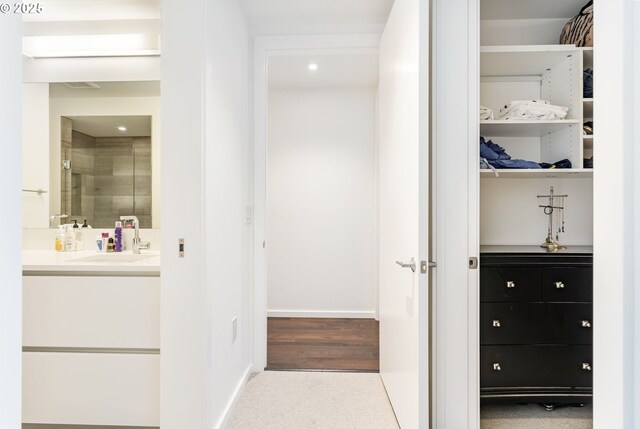 1075 NW Northrup St Unit 814, Portland, OR 97209 - interior space featuring vanity, visible vents, baseboards, a walk in closet, and a stall shower