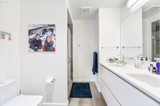 1075 NW Northrup St Unit 814, Portland, OR 97209 - bathroom with a sink, a stall shower, toilet, and wood finished floors