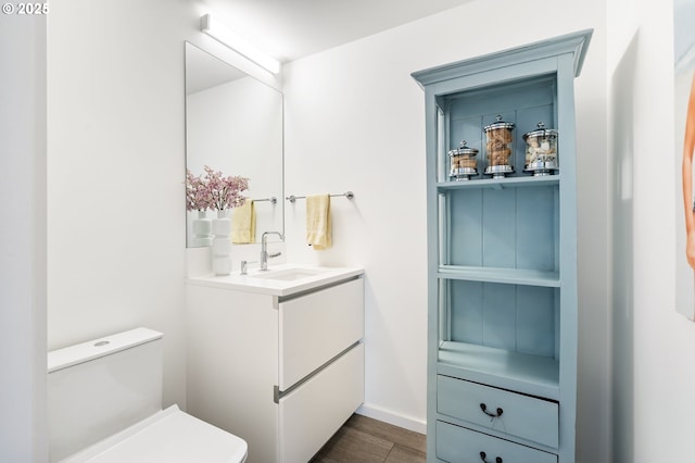 1075 NW Northrup St Unit 814, Portland, OR 97209 - bathroom featuring toilet, baseboards, wood finished floors, and vanity