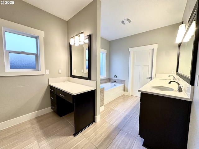 bathroom with a relaxing tiled tub and vanity