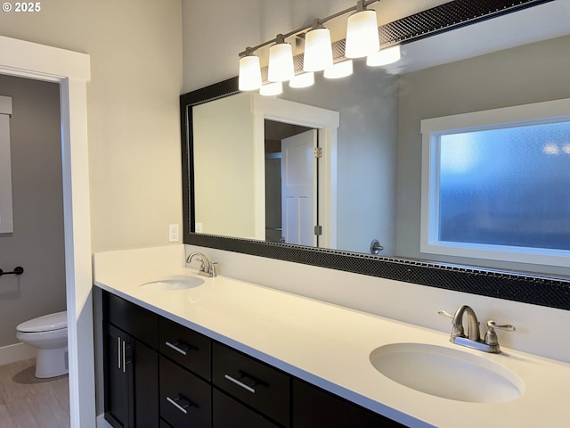 bathroom featuring hardwood / wood-style flooring, vanity, and toilet