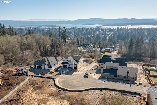 bird's eye view featuring a view of trees and a water view