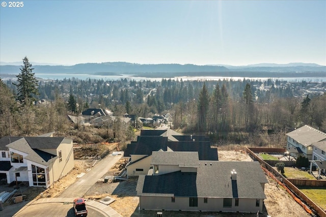 birds eye view of property featuring a mountain view and a view of trees
