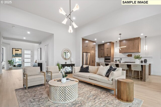 living area featuring recessed lighting, a notable chandelier, light wood-style floors, and visible vents