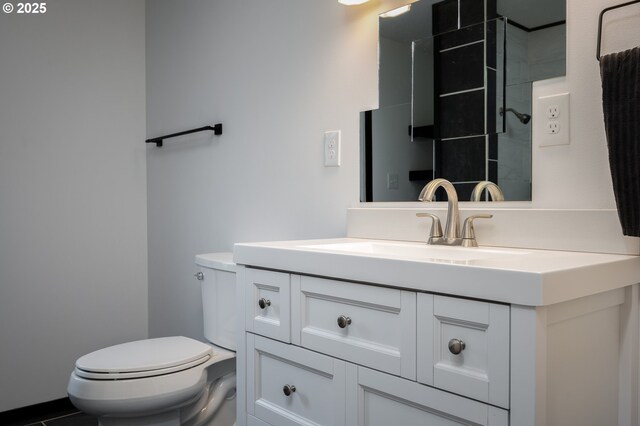 bathroom with toilet and vanity