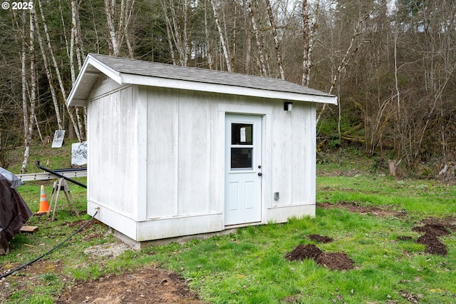 view of shed with a view of trees