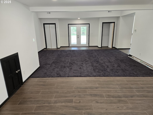 spare room with french doors and dark wood finished floors