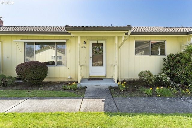 12395 SE Main St, Portland, OR 97233 - property entrance with a chimney and a metal roof