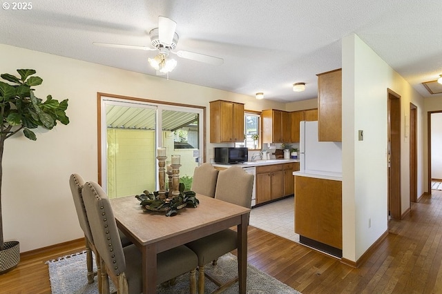 12395 SE Main St, Portland, OR 97233 - dining space featuring light wood-type flooring, ceiling fan, and a textured ceiling