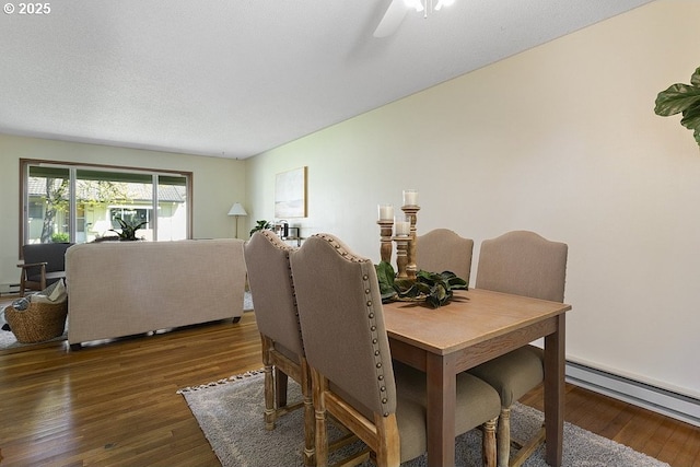 12395 SE Main St, Portland, OR 97233 - dining room featuring a baseboard radiator, wood finished floors, and ceiling fan