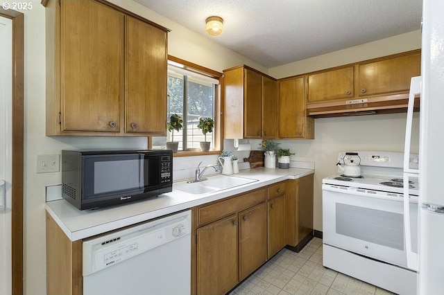 12395 SE Main St, Portland, OR 97233 - kitchen with white appliances, under cabinet range hood, light countertops, brown cabinetry, and a textured ceiling