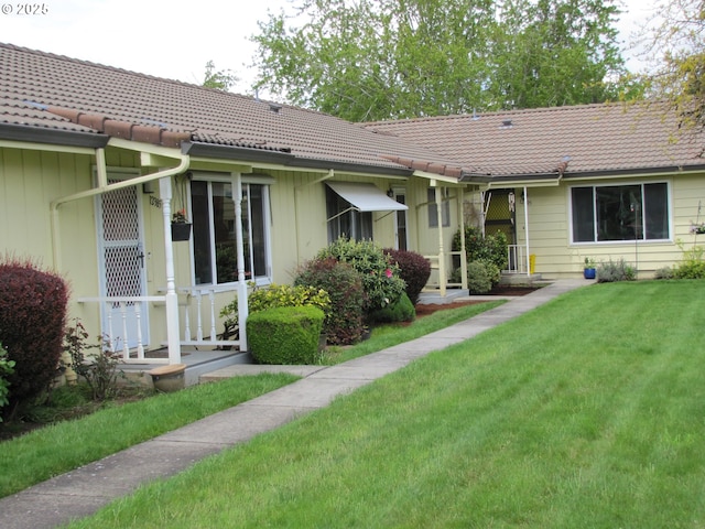 rear view of house featuring a yard