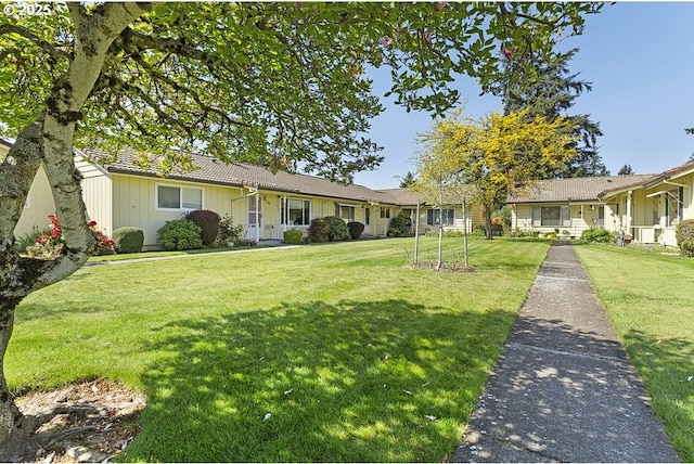 12395 SE Main St, Portland, OR 97233 - single story home with a front yard, board and batten siding, and a tiled roof